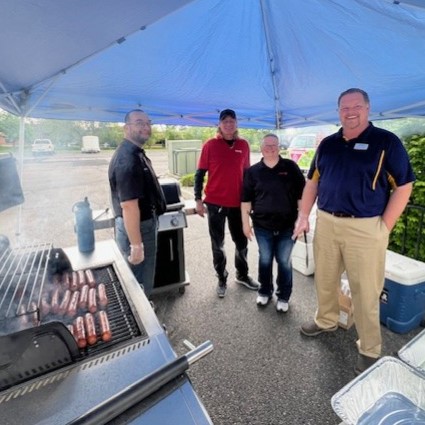 Circle K volunteers grill hotdogs