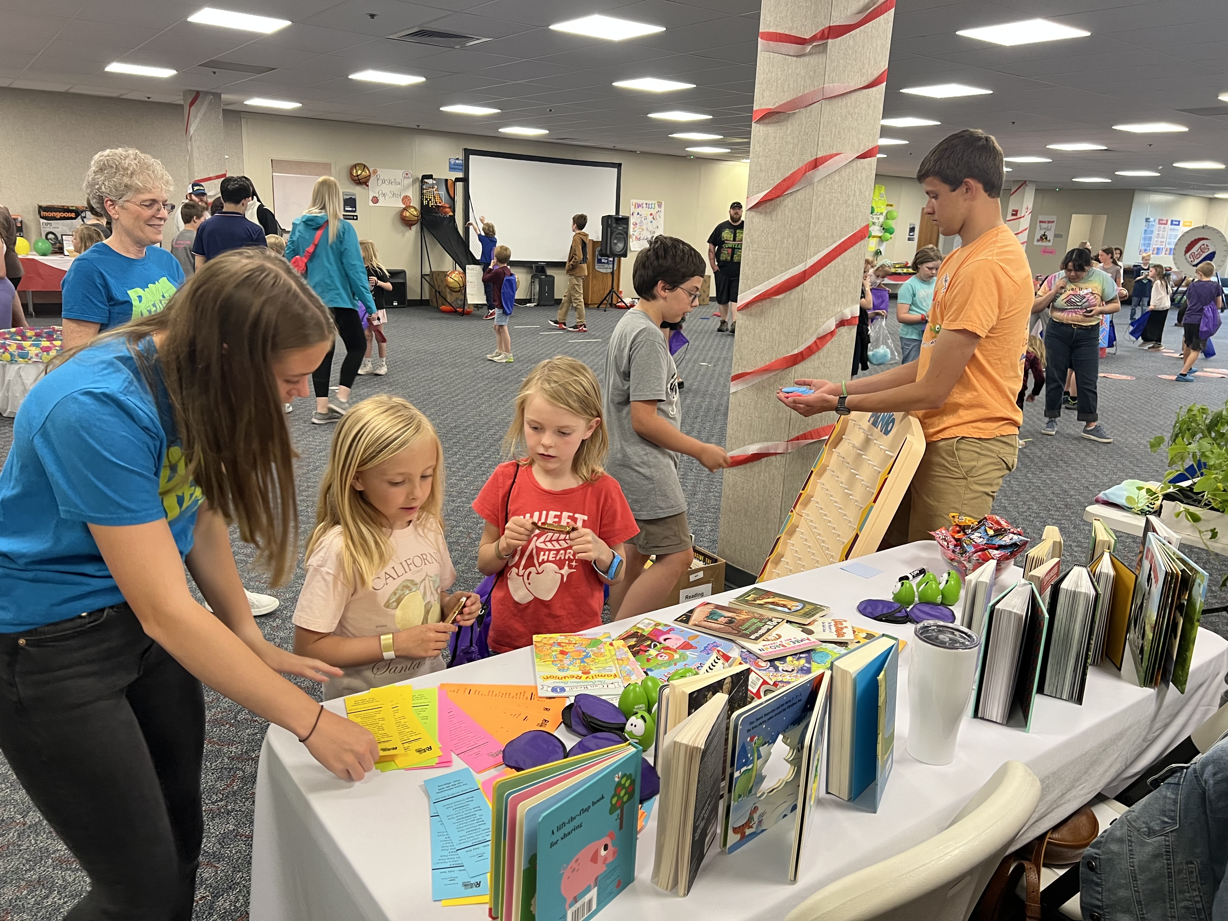 Children look at books on a table