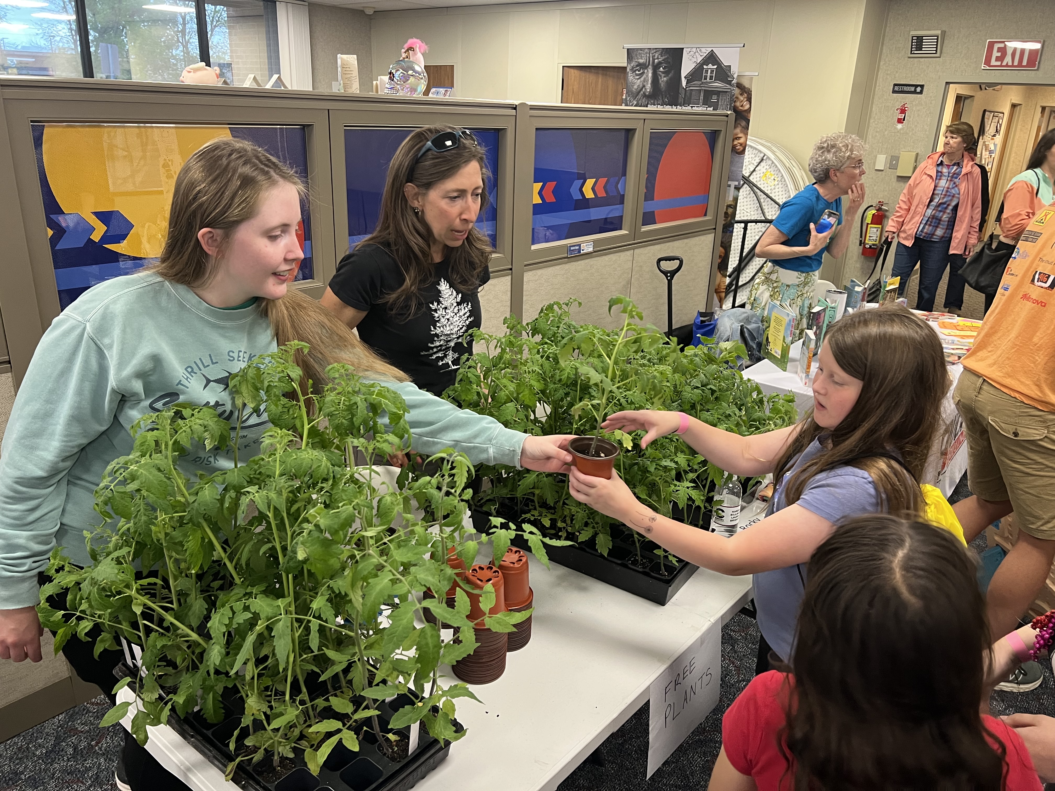 Volunteers hand out free plants to kids