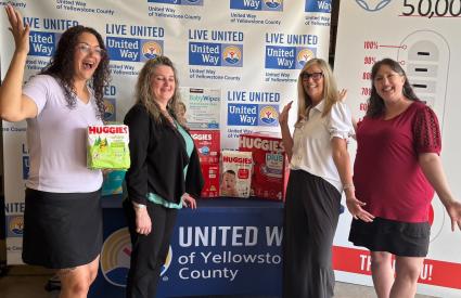 People pose while dropping off diapers
