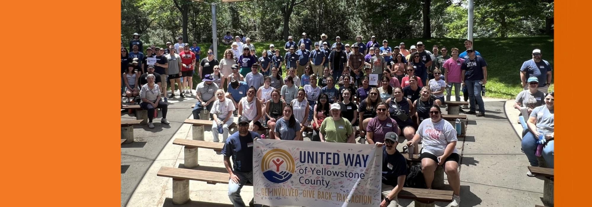 About 100 volunteers pose for a photo