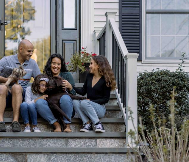 A family sits on a doorstep