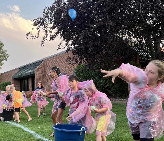 Kids throw water balloons 