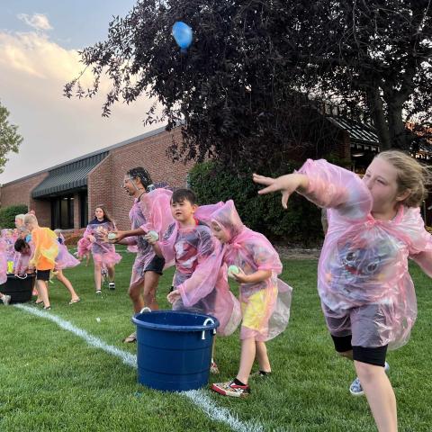 A girl throws a water balloon