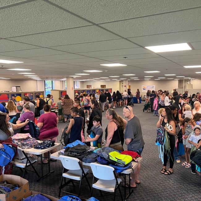 Families pack into UWYC offices to pick up school supplies and backpacks