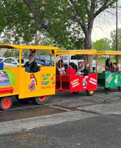 Children ride on a toy train