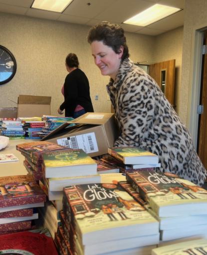 Julie from This House of Books delivers books for last year's holiday book drive. 
