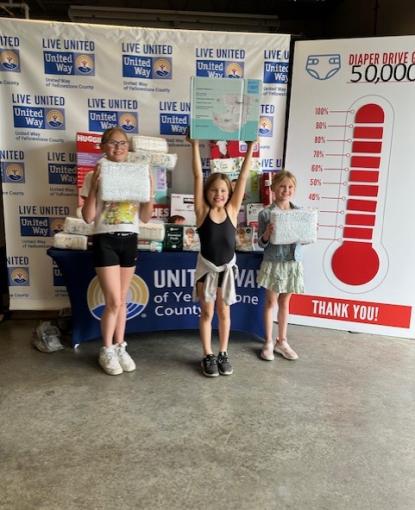 Ireland Carley, Lennox Carley, and Avery Nelson hold some of the diapers they collected and donated. 