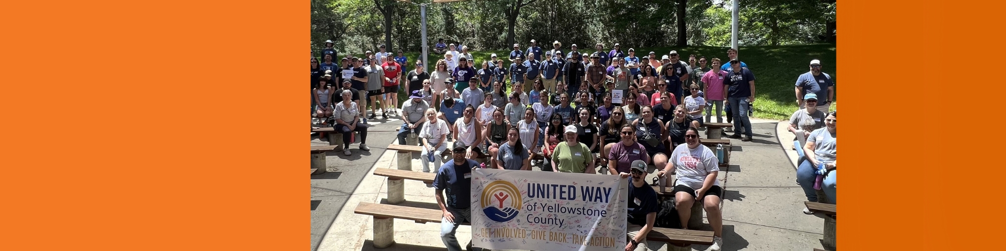 About 100 volunteers pose for a photo